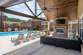 Outdoor pavilion with fireplace, flat screen tv, and food area